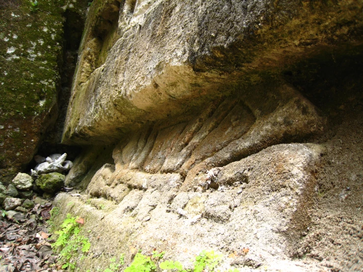 the rock faces are carved into the cliff side