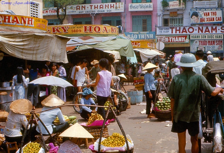 a market with some people shopping on the side of the road