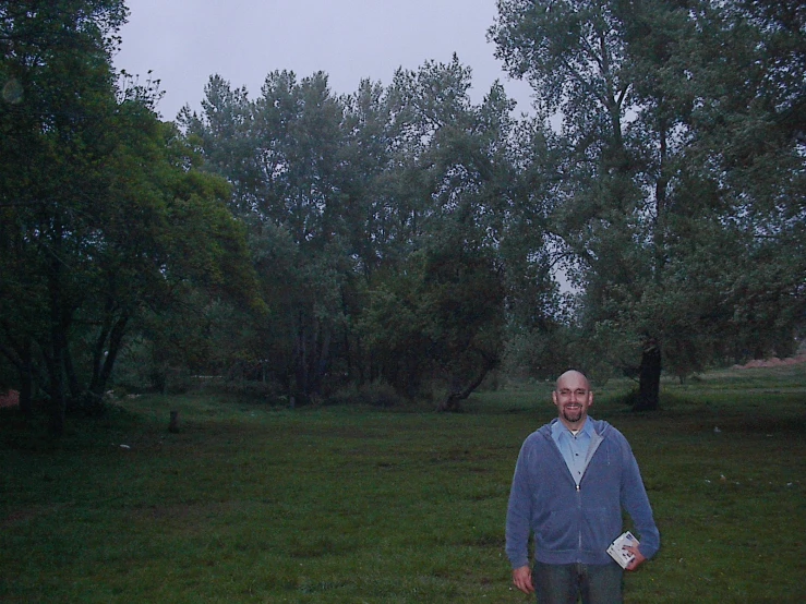 a man is walking through a grassy field