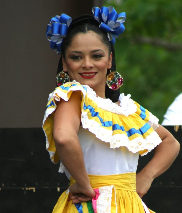 a woman dressed in mexican attire smiles