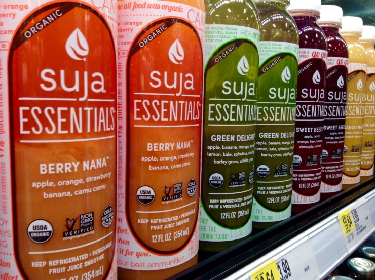 a row of beverage bottles sitting on top of a display case