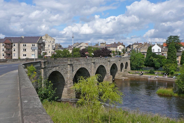 the large bridge has two arches spanning the river