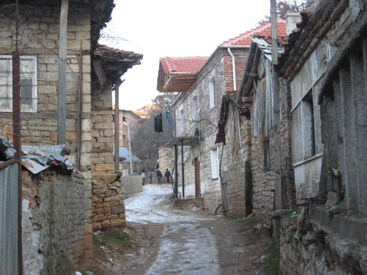 a stone street with some old buildings on the side of it