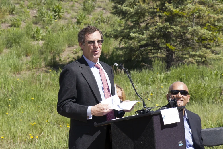 an image of the man standing at a podium talking