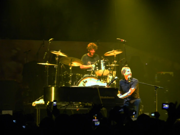 a couple of people playing drums and drums on stage
