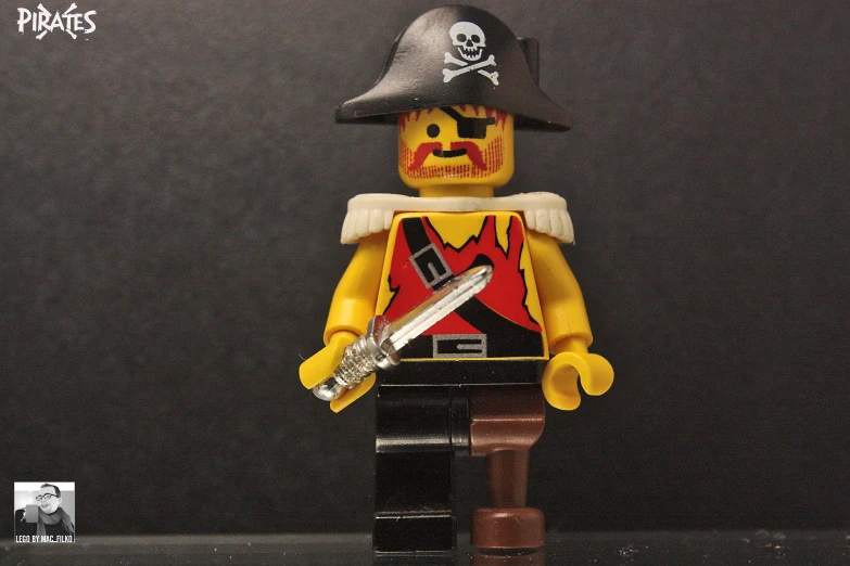 a lego figurine holding a sword in front of a black background