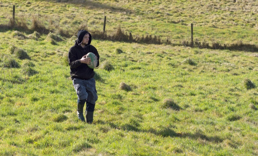 a man holding a frisbee in a field