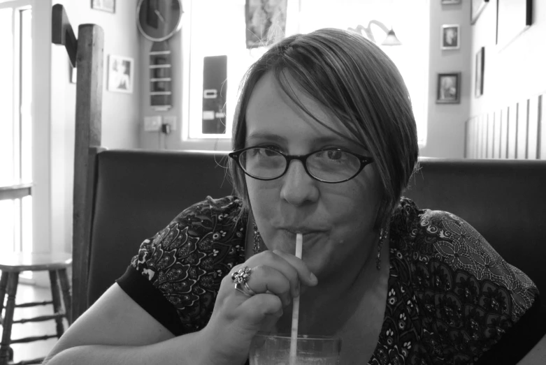 a women who is holding a glass and smoking