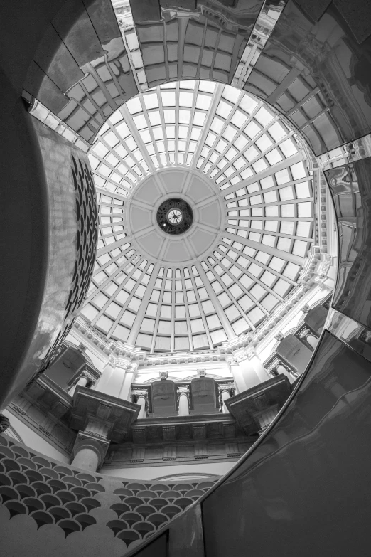 the view from the floor looking up at an arched roof and stained glass windows