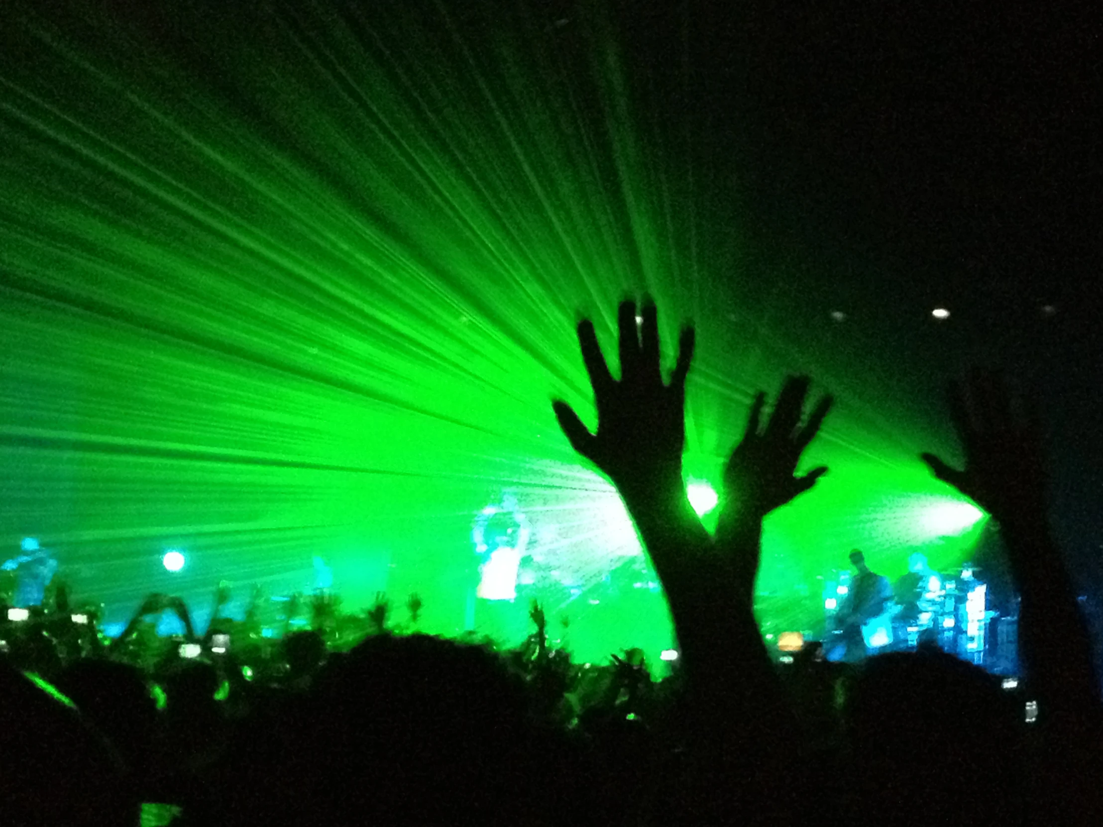 a po of a concert with hands in the air