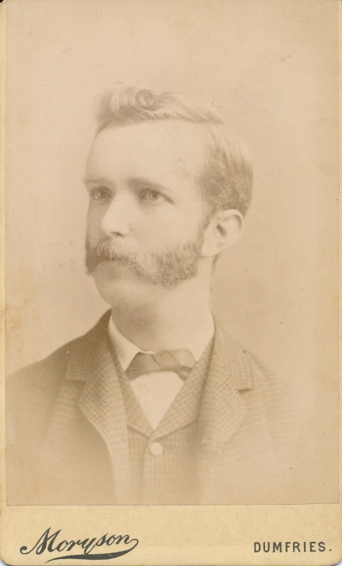 a man with a beard wearing a suit and bow tie