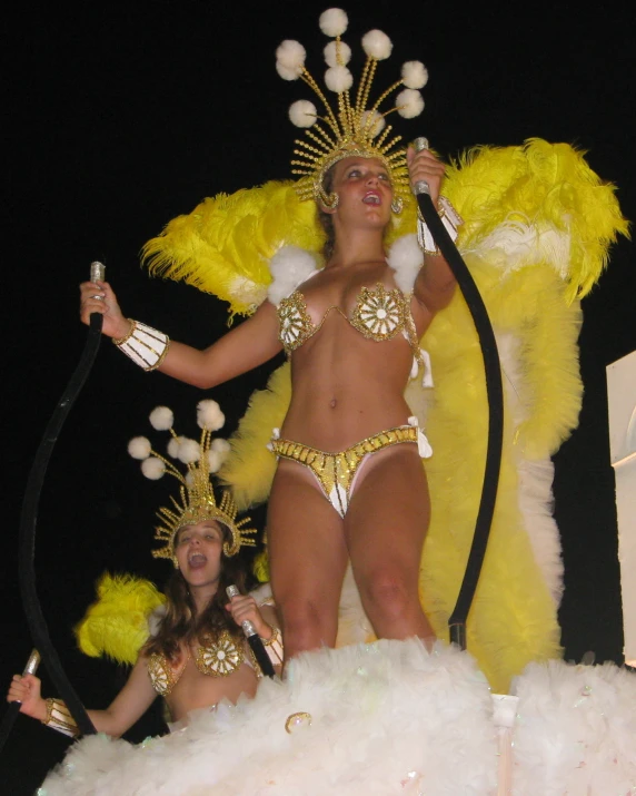 two beautiful young women dressed in gold with their costumes