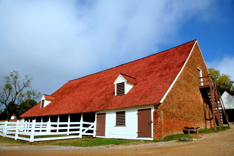 an old, brick barn with brown shutters on the side