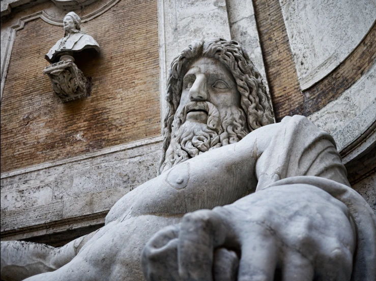 an image of a statue sitting on top of a wall