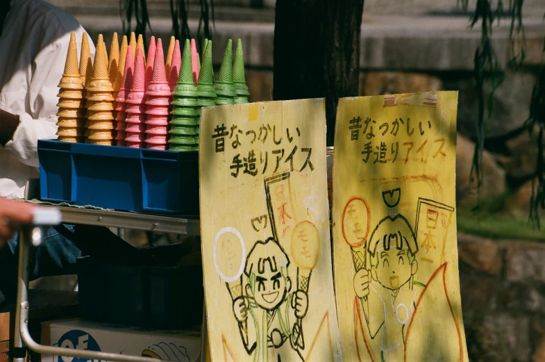 yellow and pink umbrellas, on display behind a blue truck