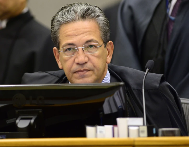 a judge sitting in front of a computer monitor