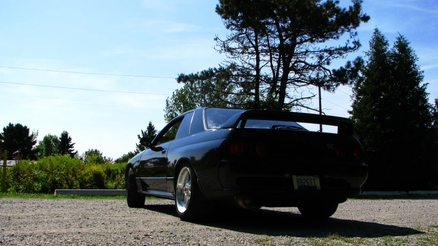 the back end of a black car with it's trunk open