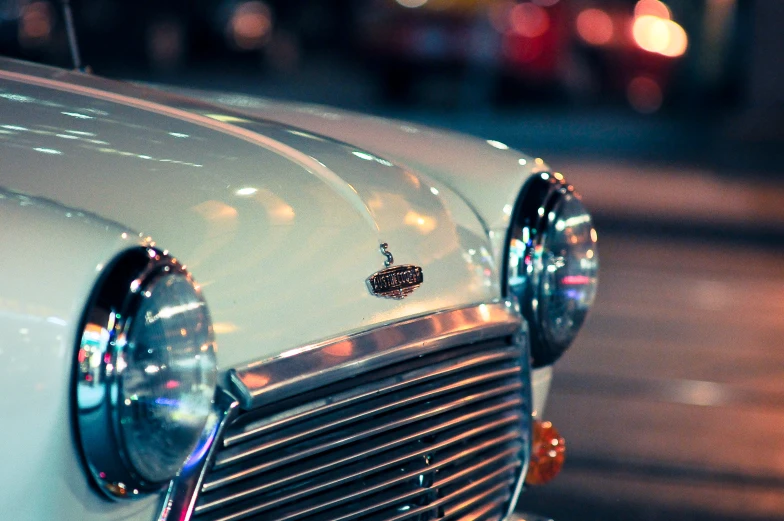 the grills of a vintage car with a tiny piece of jewelry