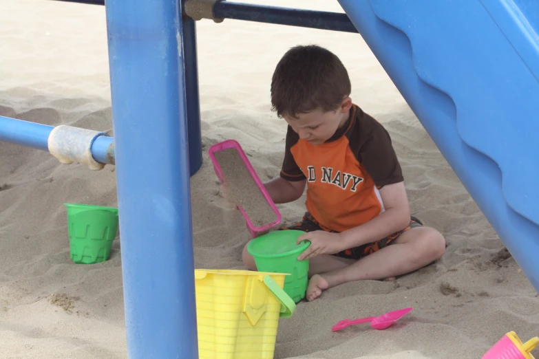 a  plays with sand on the beach