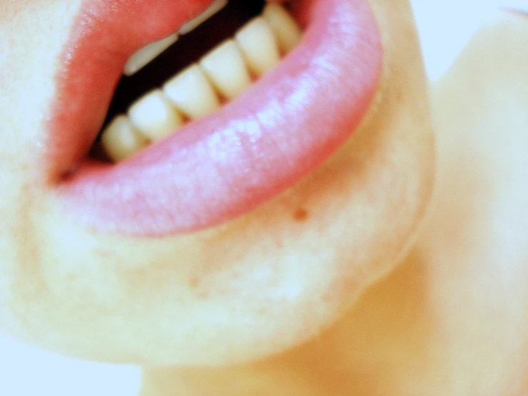 a woman with a toothbrush sticking her tongue out