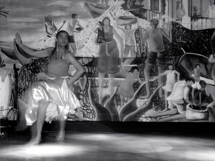 a woman standing in front of a mural on the wall