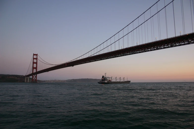 a boat sailing under the golden gate bridge