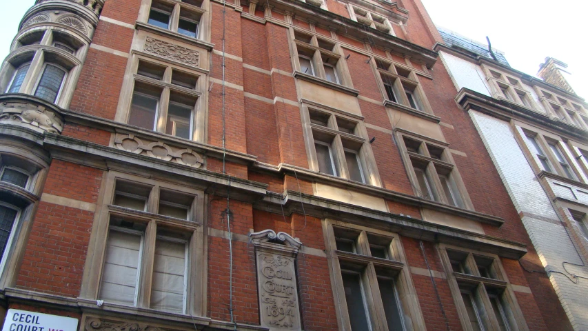 a large red brick building with an old fashioned clock