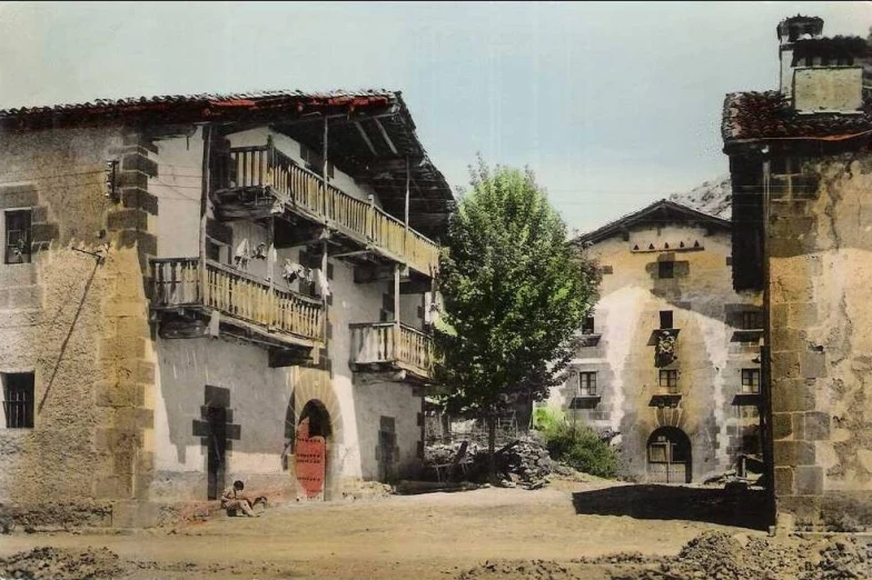 two old style buildings near a few trees