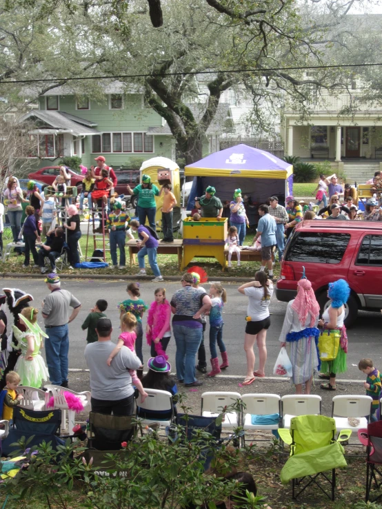 people at a carnival near a tent in a small town