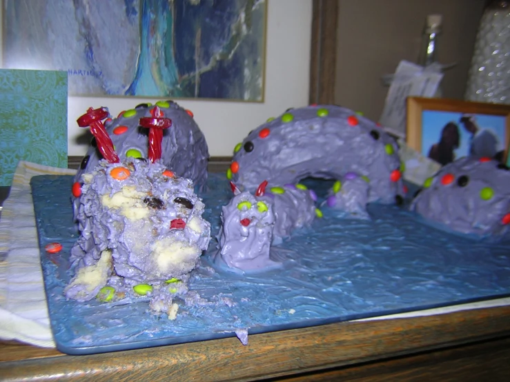 a table topped with purple desserts and pictures