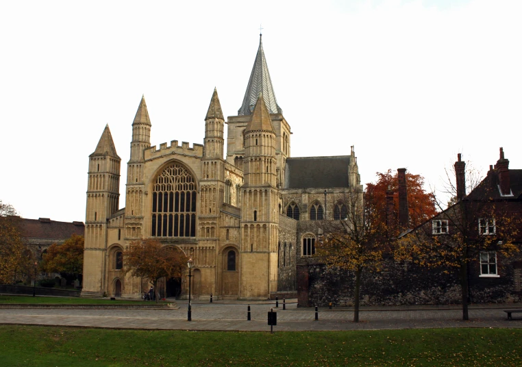 a church with stone walls and towers in autumn