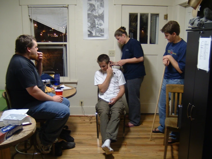 a group of men in a room with some chairs