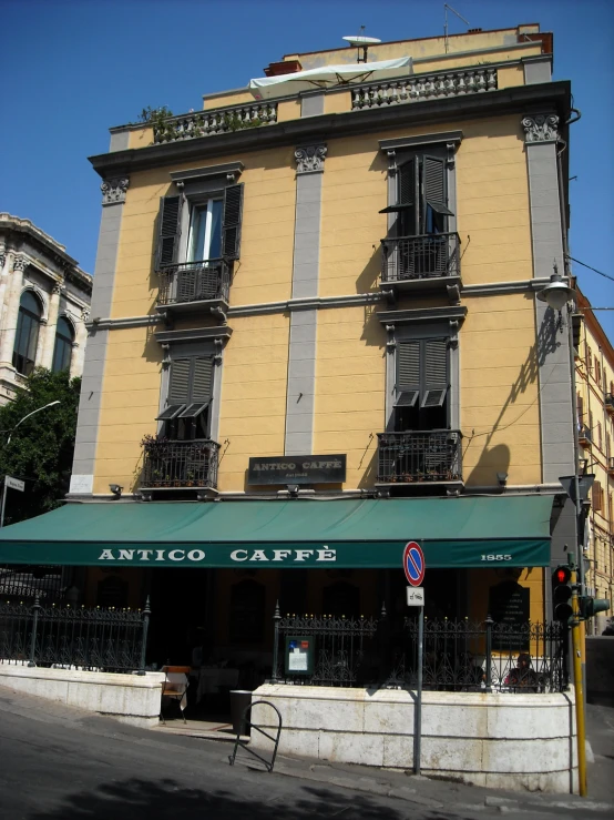 a tan building with two stories sitting on the corner