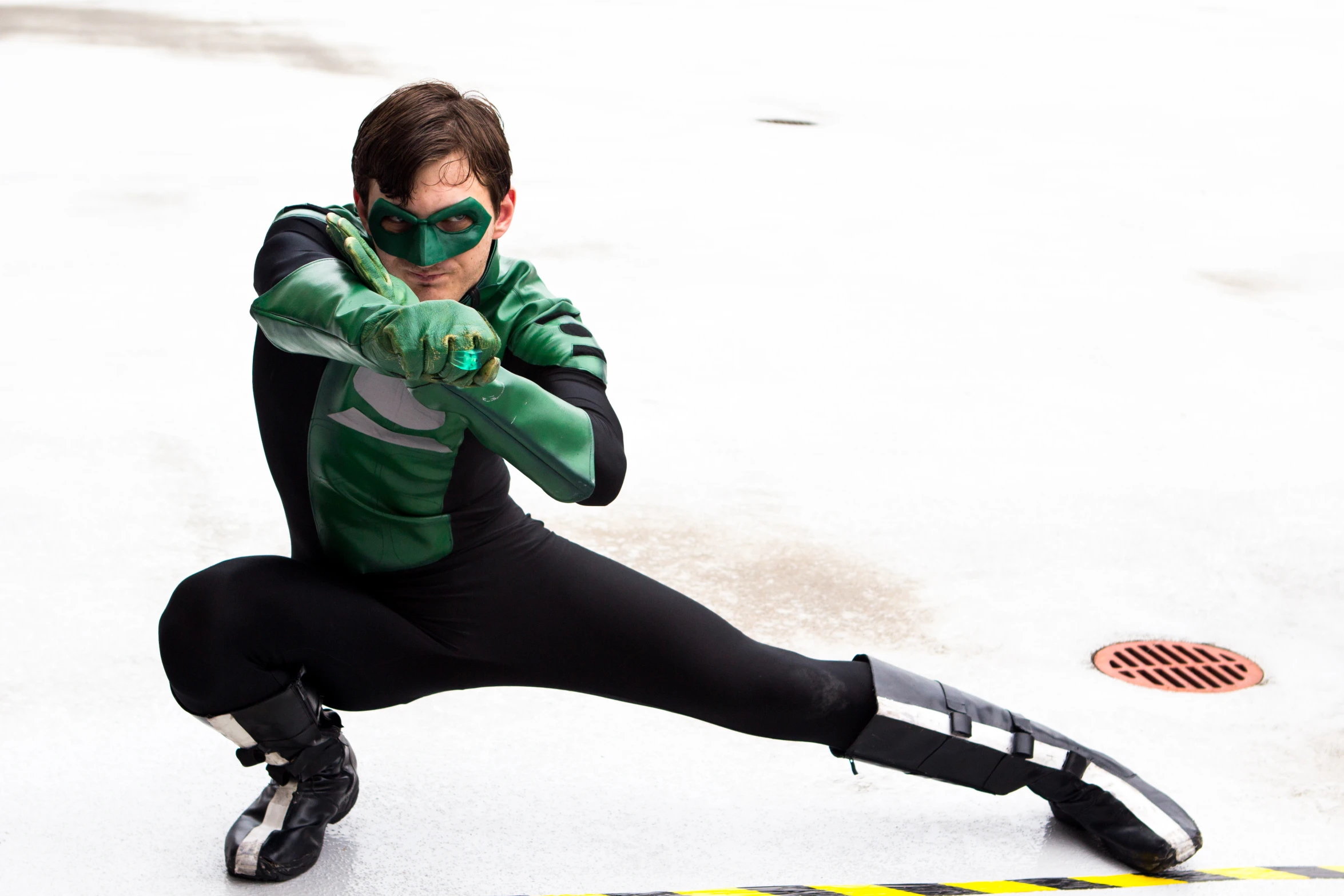 a young man posing for a picture with his green arrow in hand