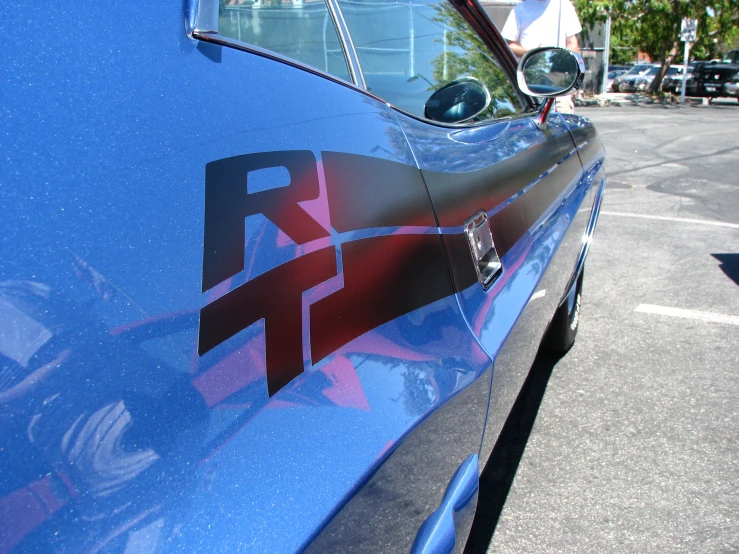 a blue chevrolet with purple and red accents parked