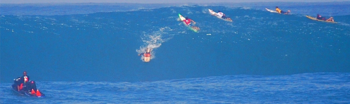 a number of people on surfboards in the water