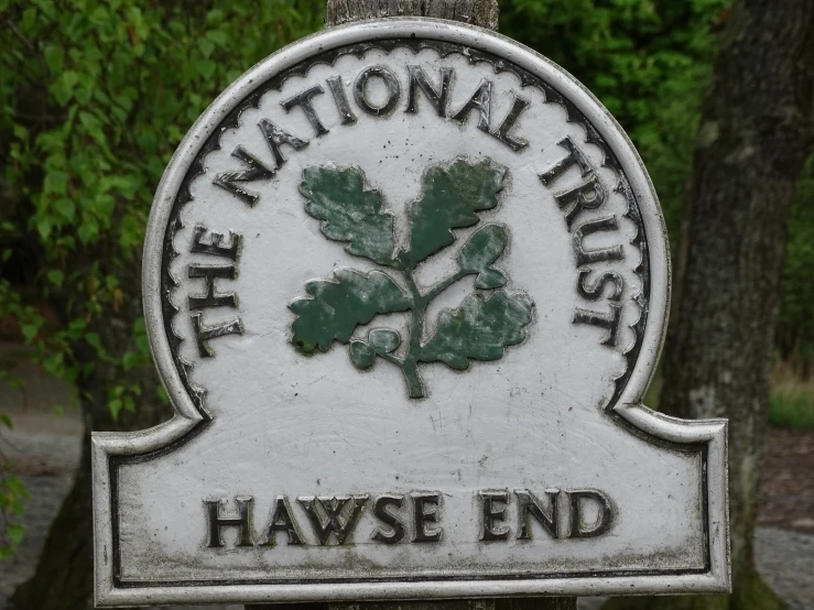 the national trust sign posted on the tree trunk