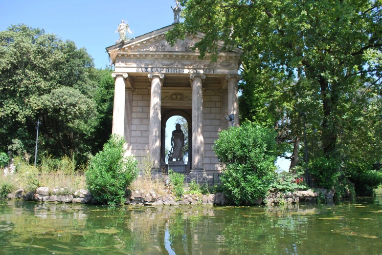 the old house sits by the pond has columns