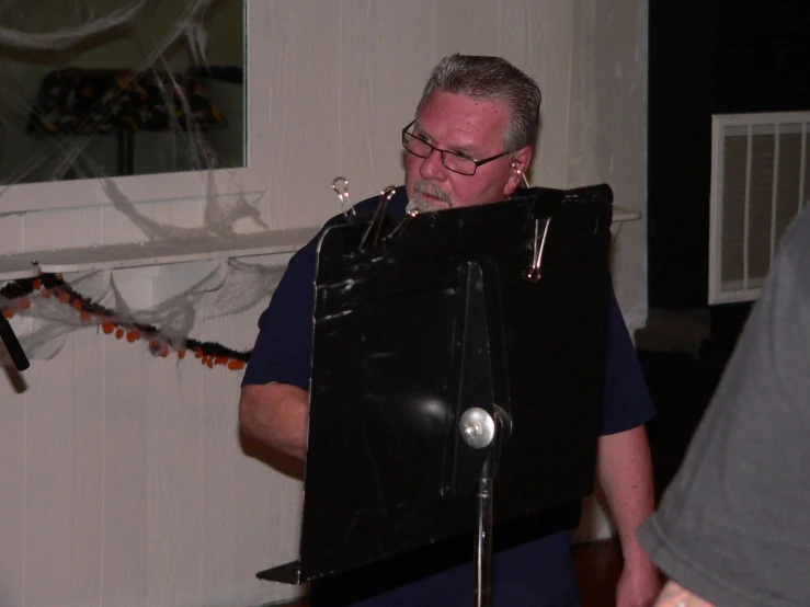 a man standing next to a black computer case