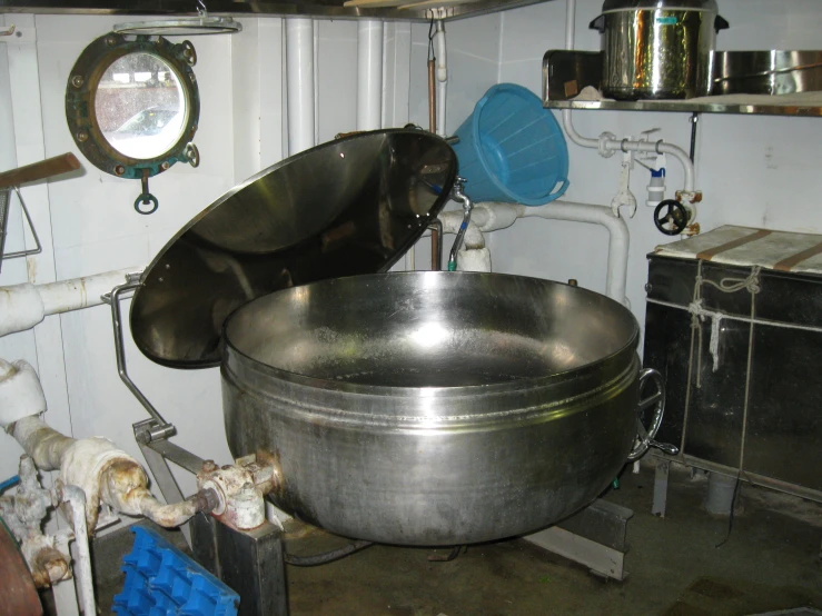 a large bowl is on top of a steel sink