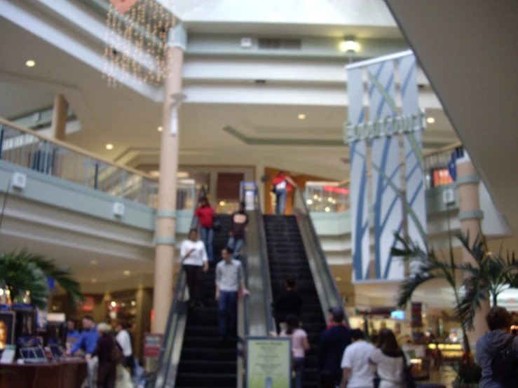 people stand at the bottom of the escalator and walk up to the top