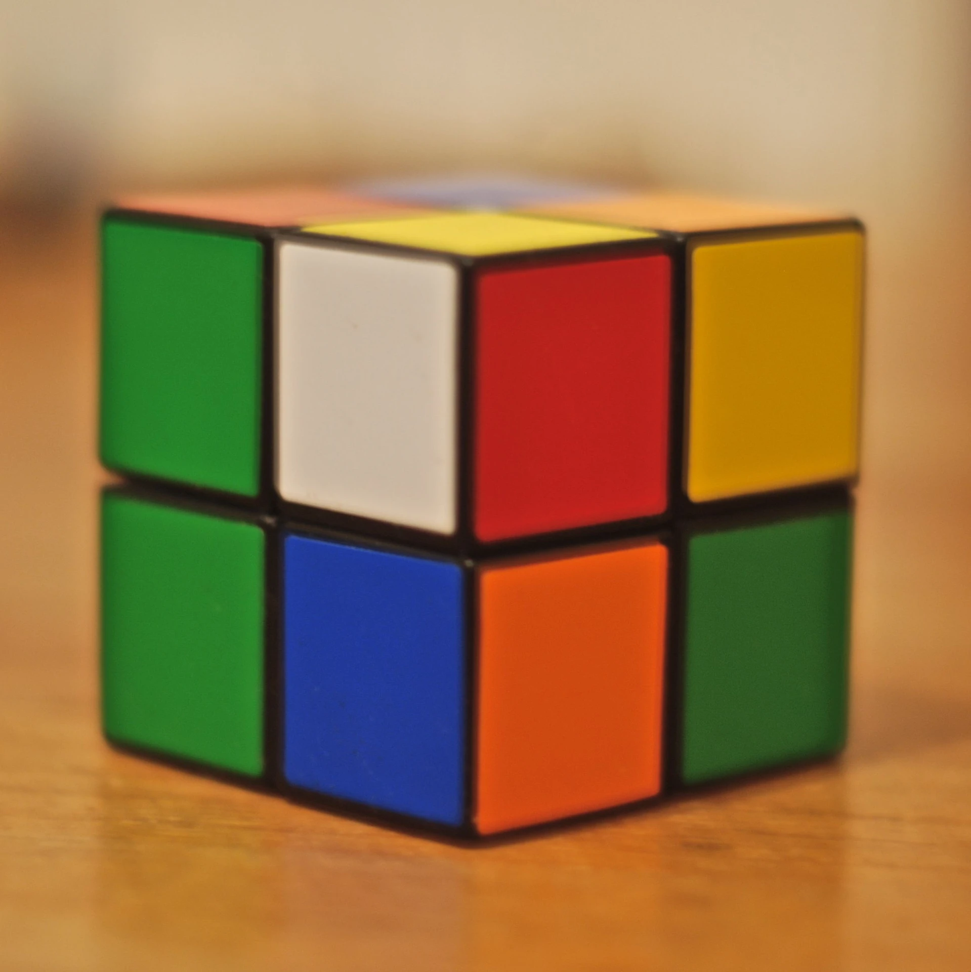 a toy cube sitting on top of a wooden table