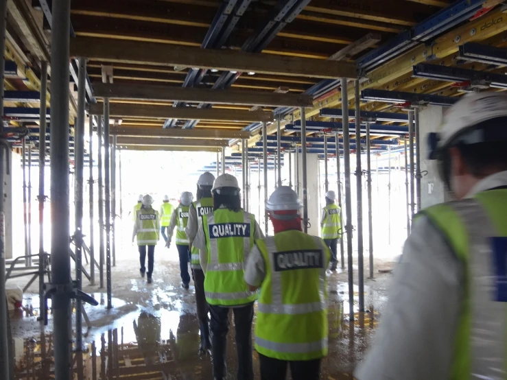 many construction workers walk along the road as they stand