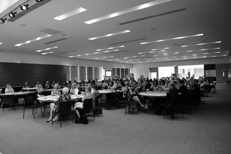 a room filled with lots of people sitting at desks