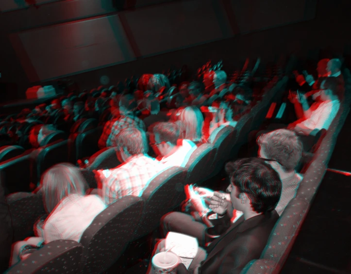 a crowd of people sitting next to each other in seats