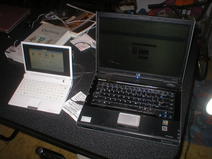 a laptop computer next to a tablet computer on a table