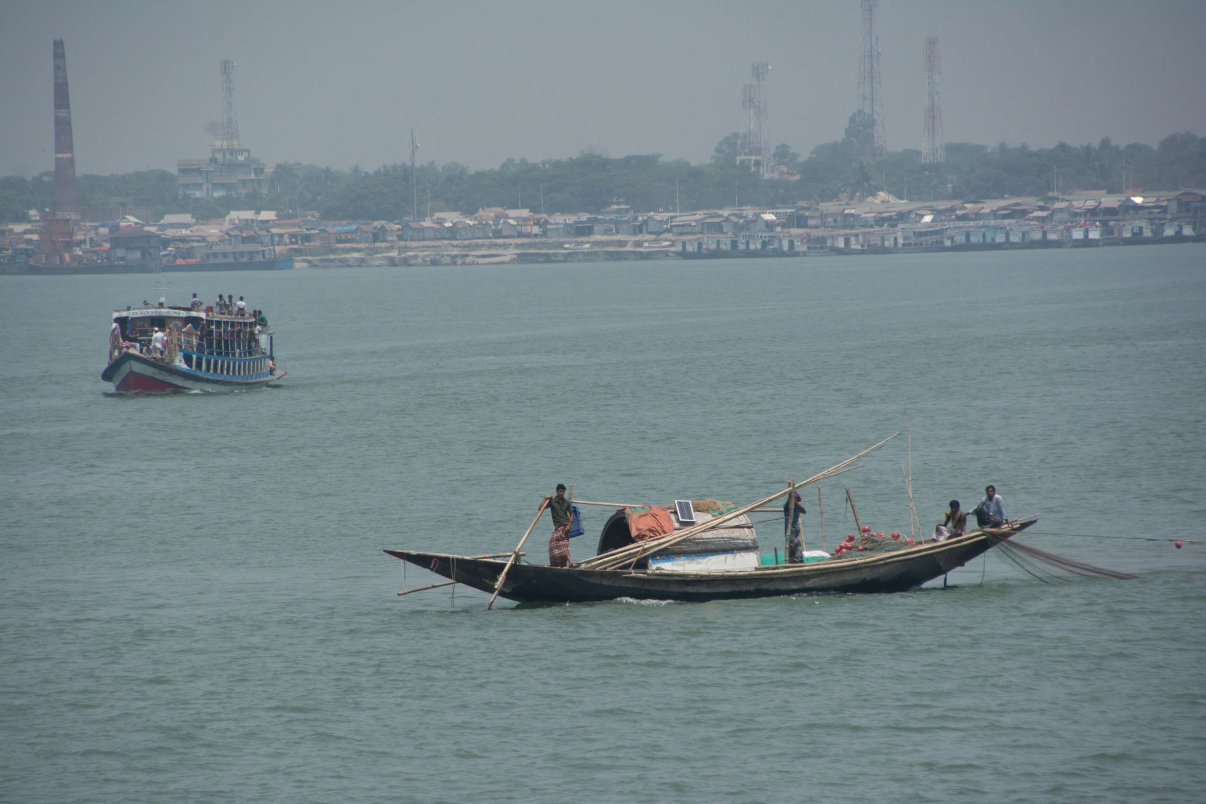 two boats with people on them traveling in the water