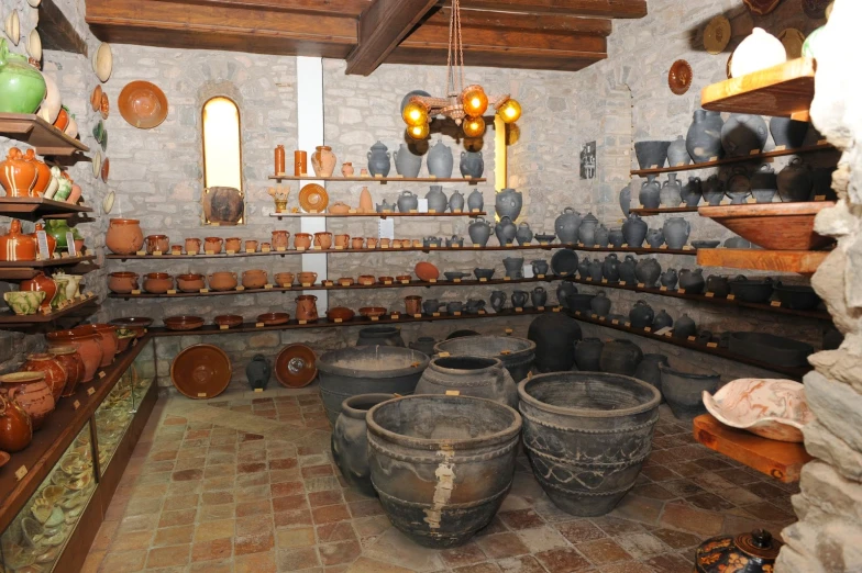 a room filled with old buckets sitting under a light