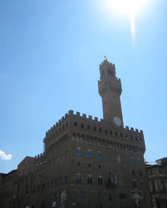 a very tall brick building with a clock tower