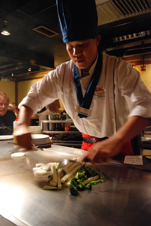 a chef standing in a kitchen preparing food